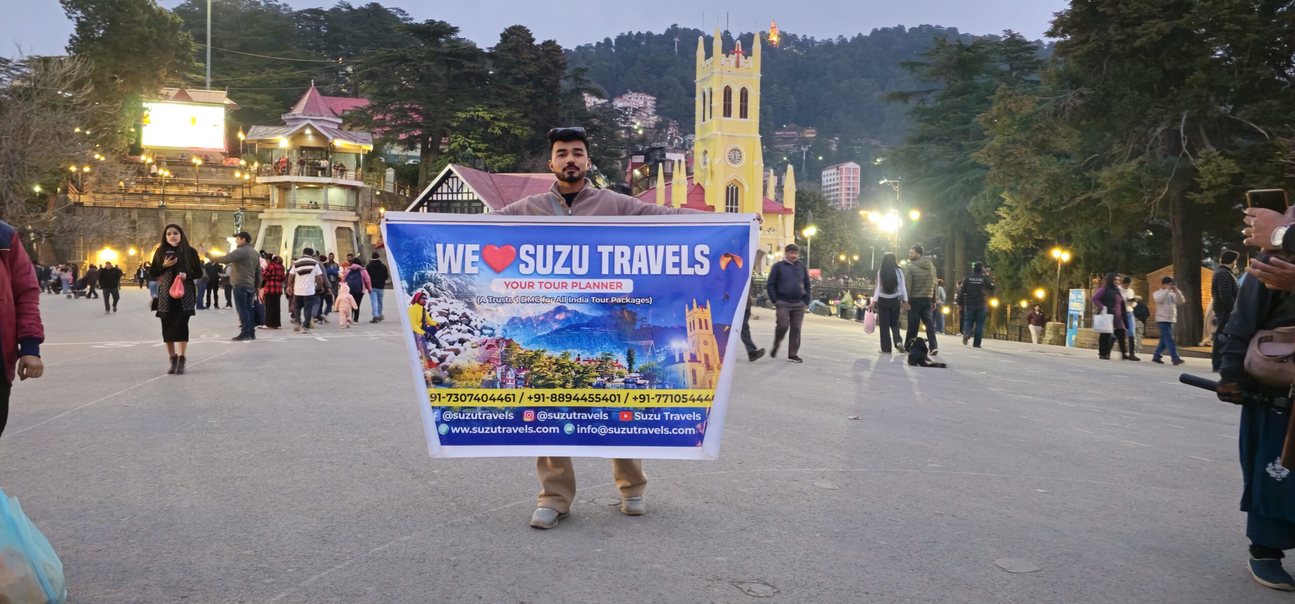 a man holding a sign in front of a building