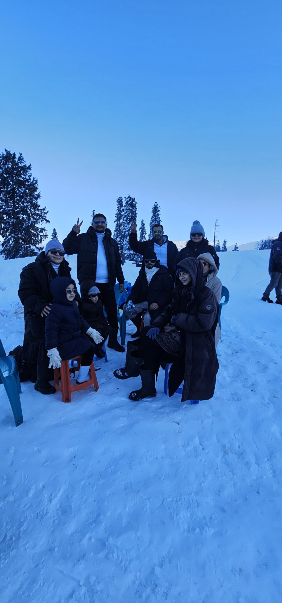 a group of people posing for a picture in the snow