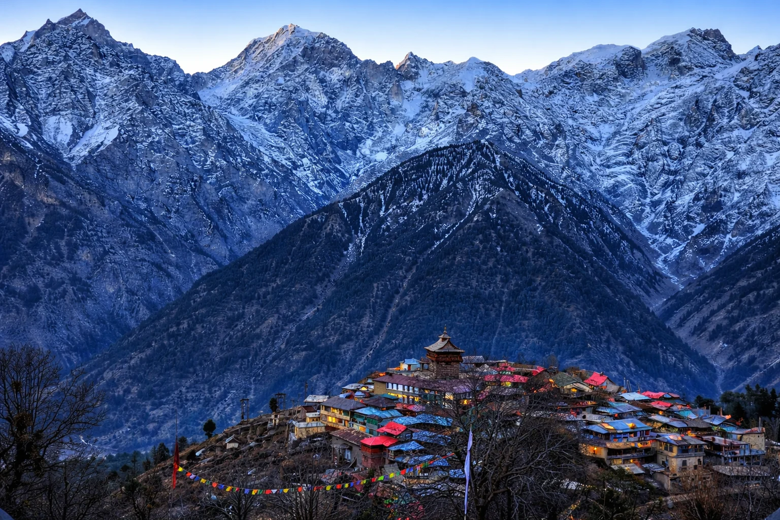 Snow peaks above a hill town on the Shimla Manali route