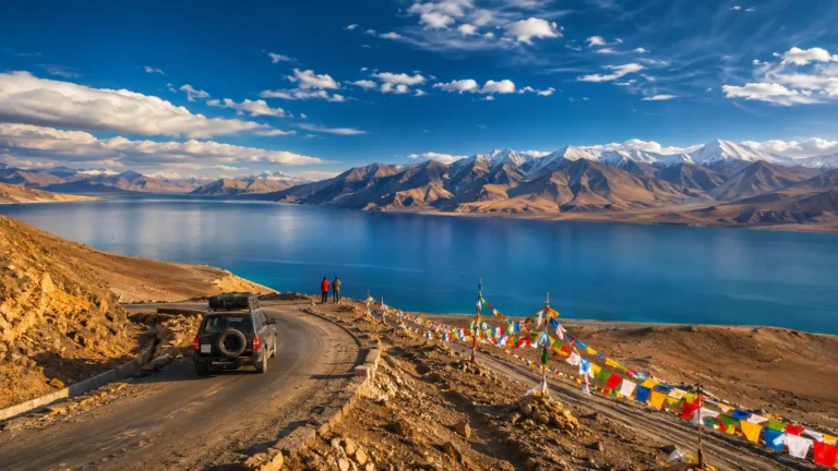 SUV on a scenic Ladakh road trip near Pangong Lake with Himalayan mountains in 2026