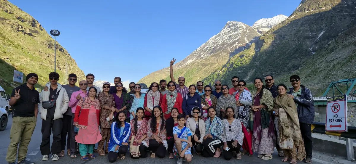 Large Suzu Travels group in Lahaul valley below snow peaks