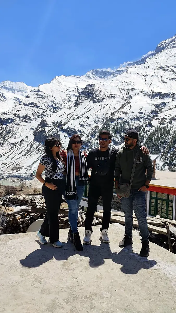 Suzu Travels guests with snow mountains in Spiti valley