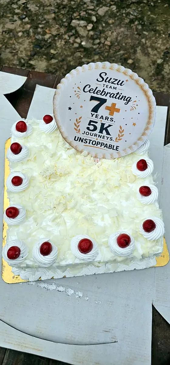 Suzu Travels team cake celebrating 7+ years and 5,000+ journeys