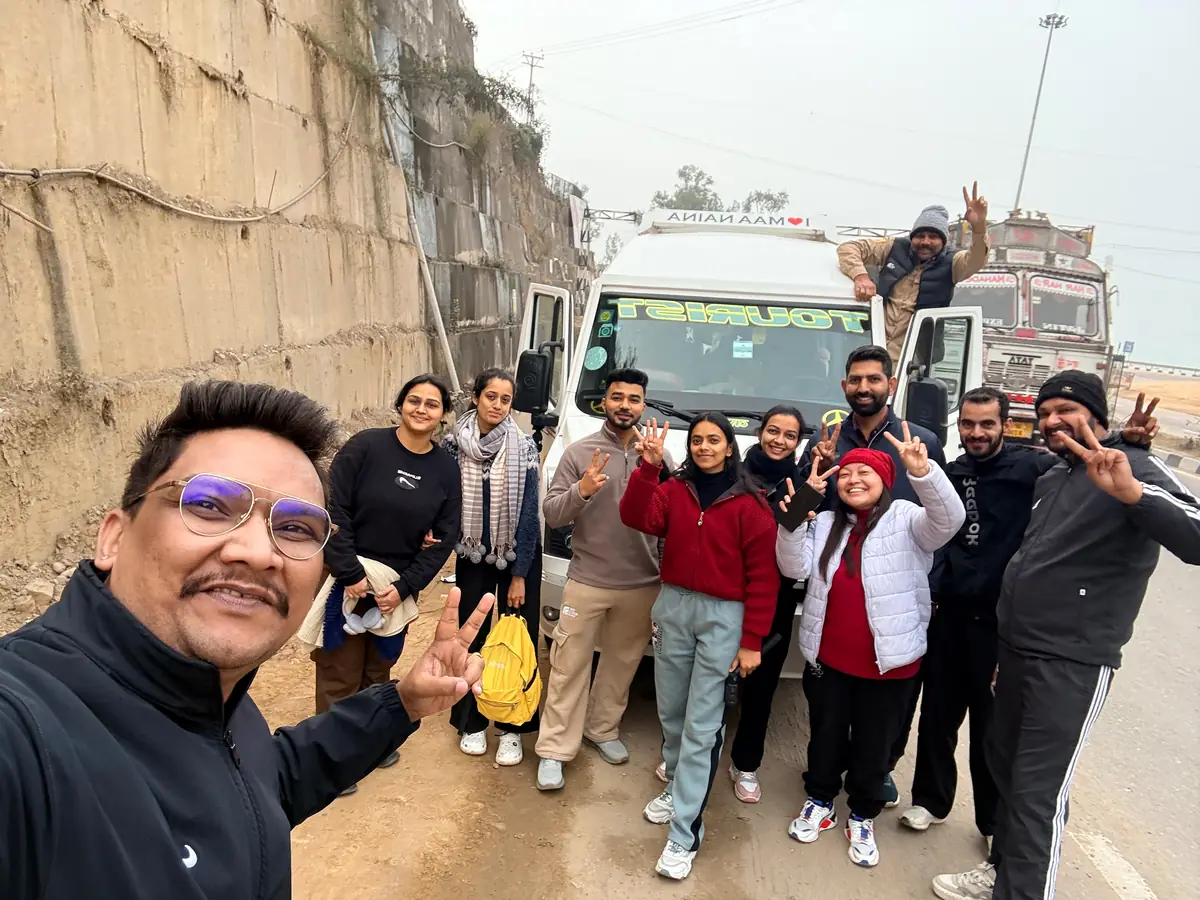 Suzu Travels group with their tempo traveller on a road trip