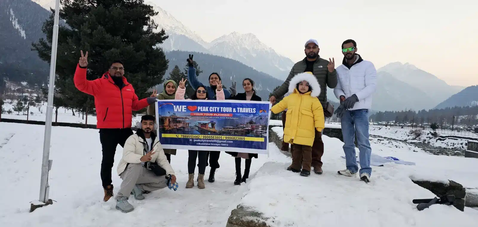 kashmir local partner team pahalgam Suzu Travels guests and the local Kashmir partner team in the snow at Pahalgam