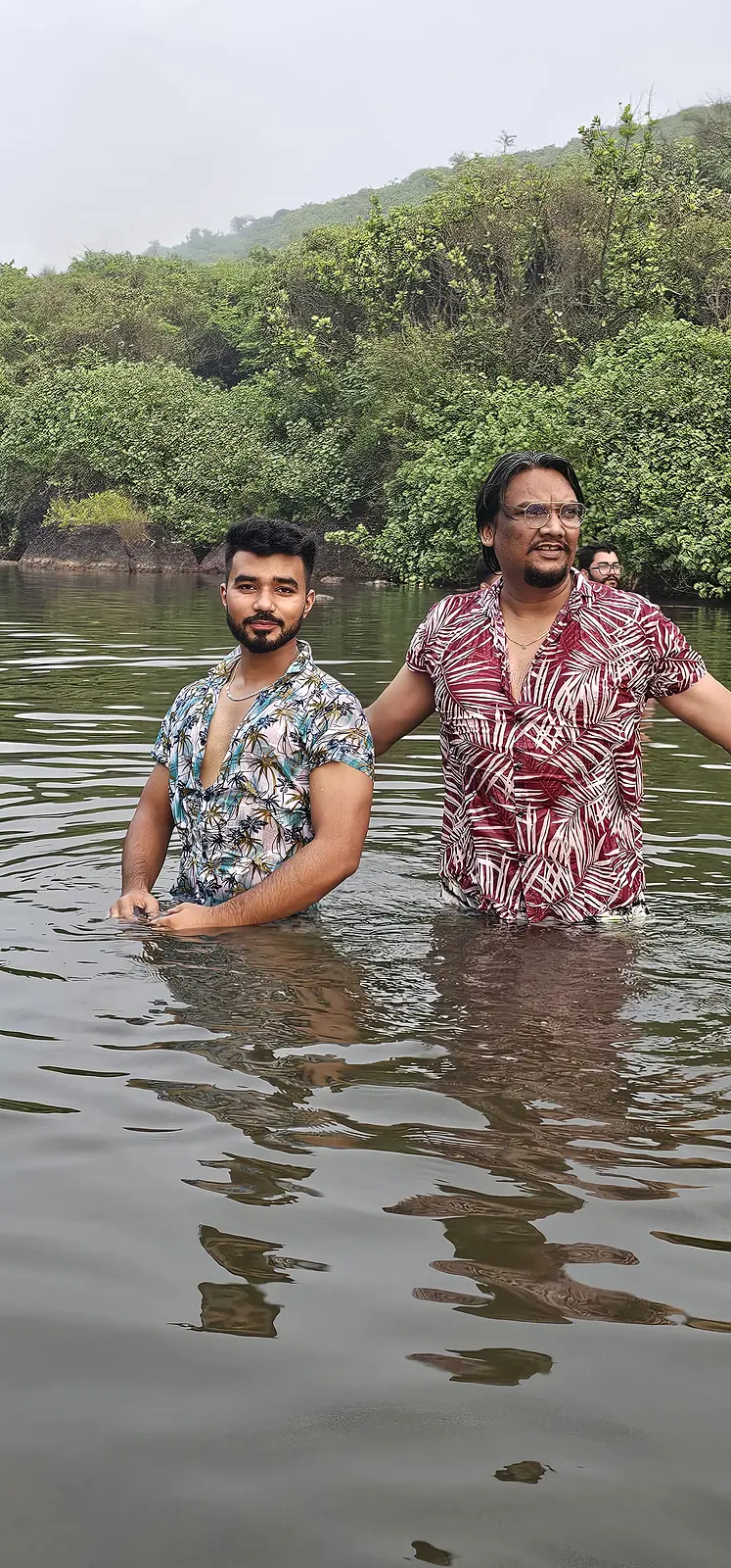 Travellers enjoying a backwater swim surrounded by greenery in Goa