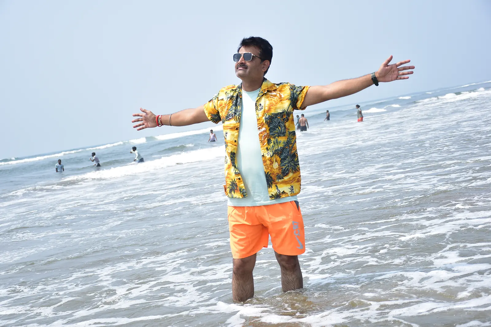 Traveller with arms wide open on a Goa beach