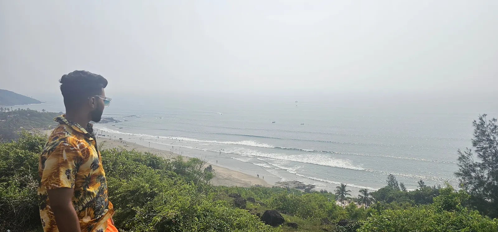 Traveller looking out over the sea from a Goa cliff viewpoint