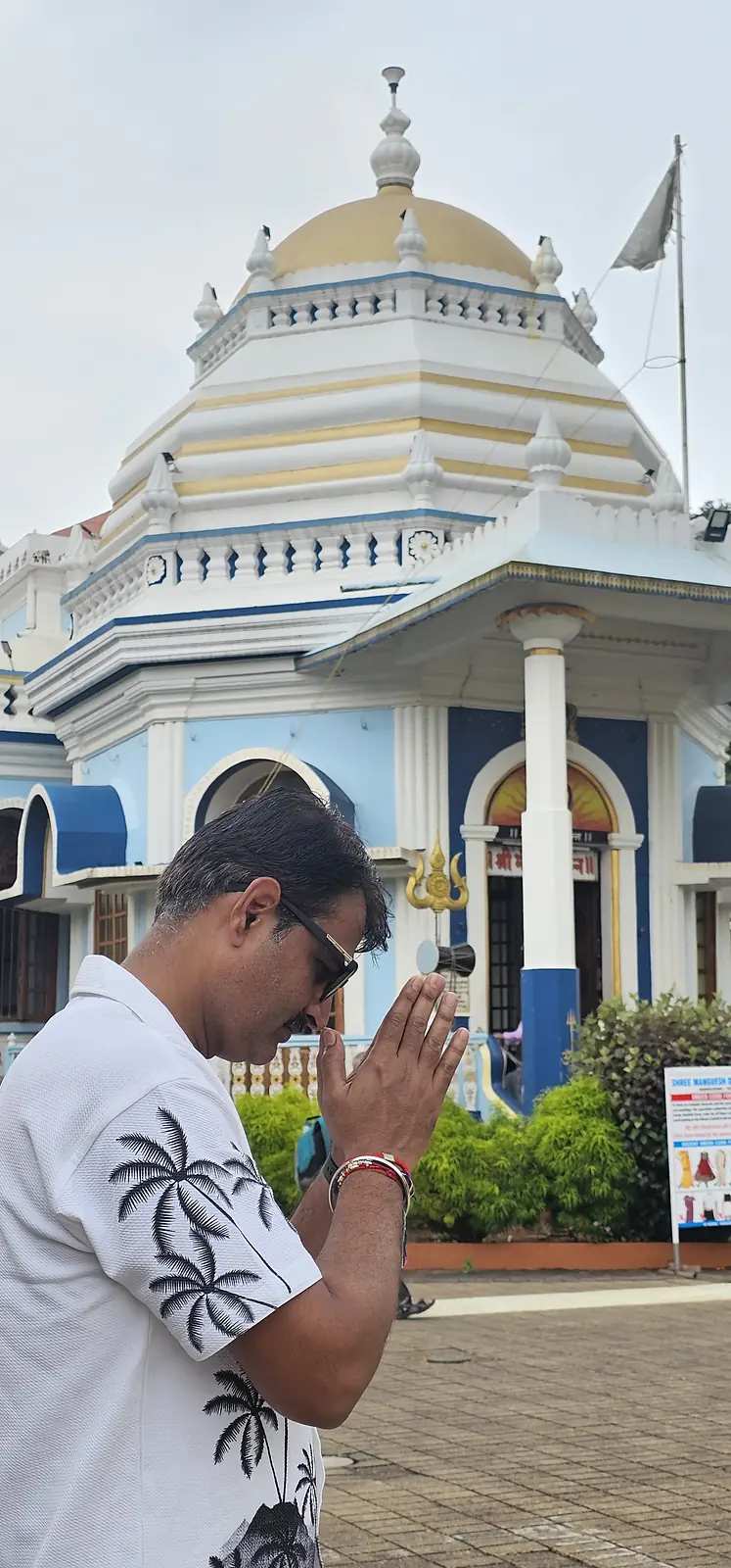 Traveller visiting a white temple in North Goa
