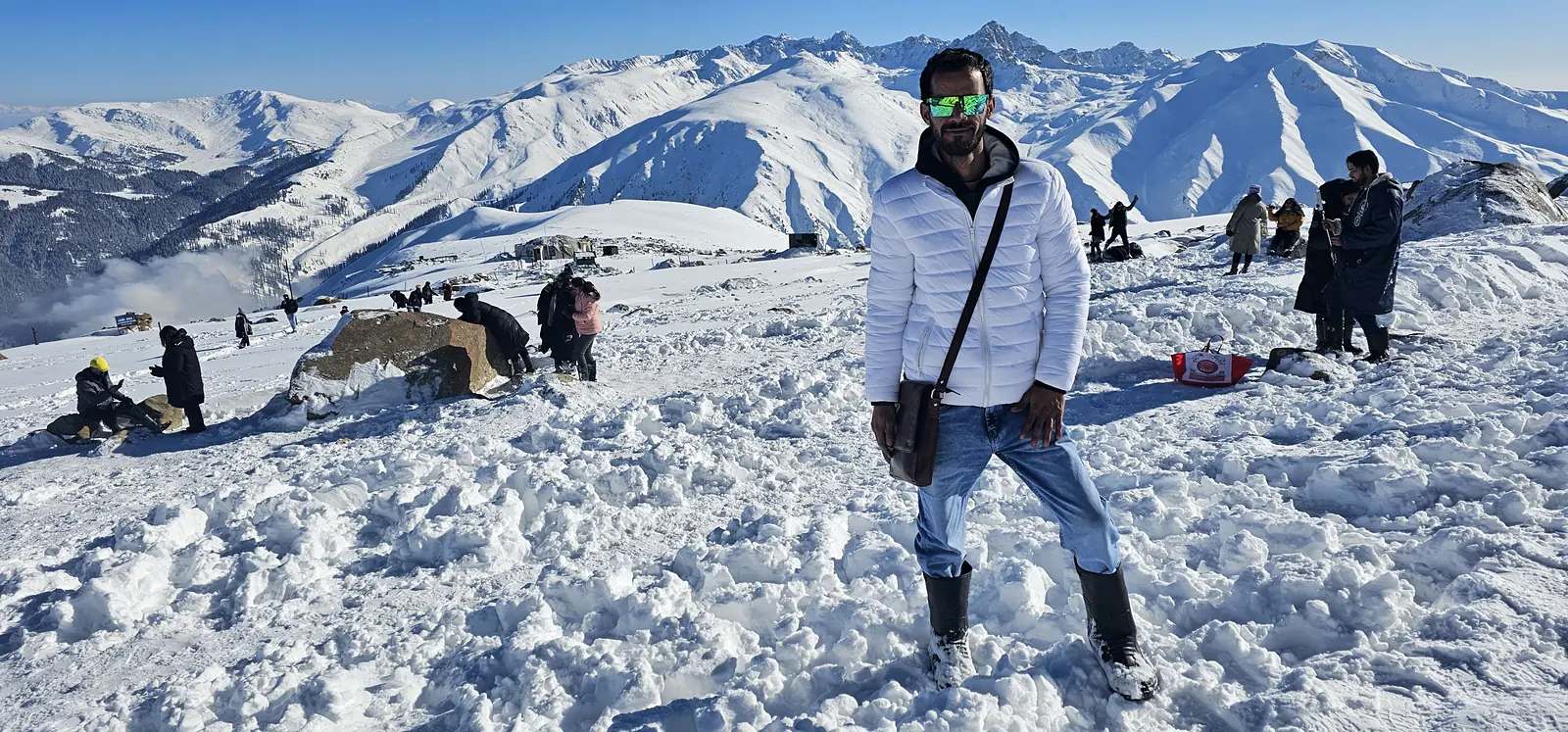 Traveller with snow-capped peaks at Gulmarg, Kashmir