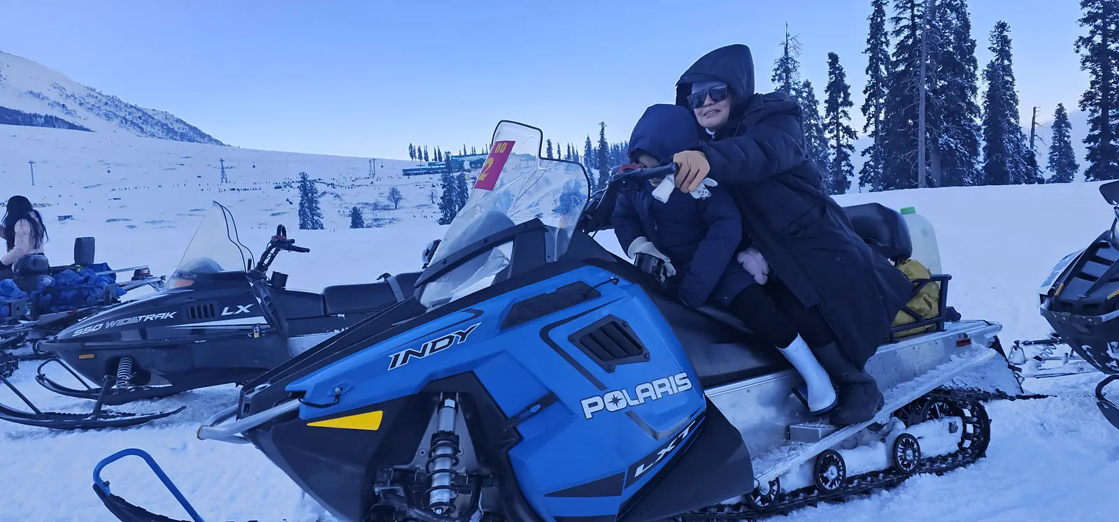Couple on a snowmobile ride in Gulmarg