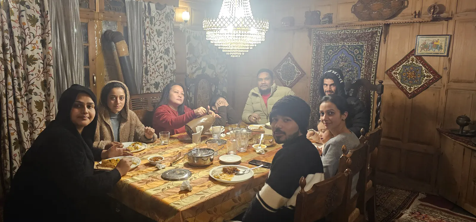 Family enjoying a traditional Kashmiri dinner on tour