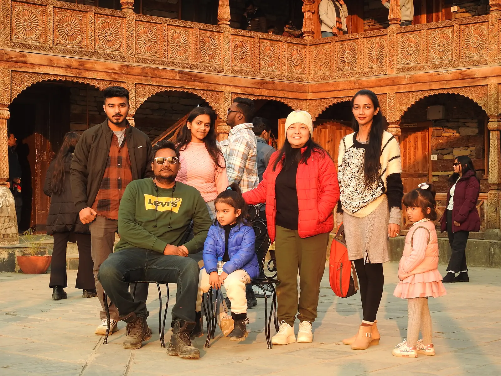 Tour group in the carved wooden courtyard of Naggar Castle