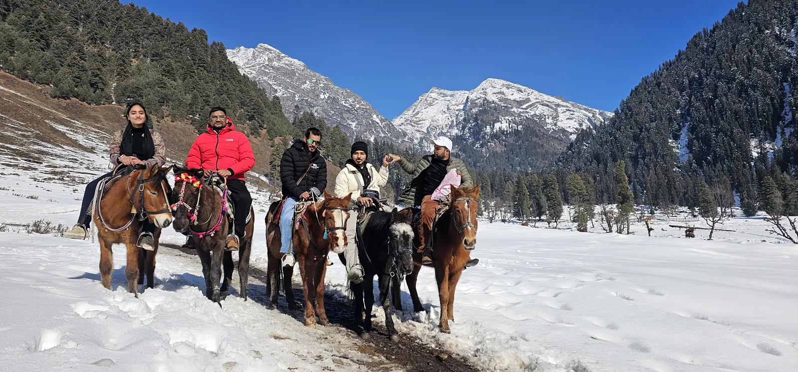 Pony ride through a snowy valley in Pahalgam, Kashmir