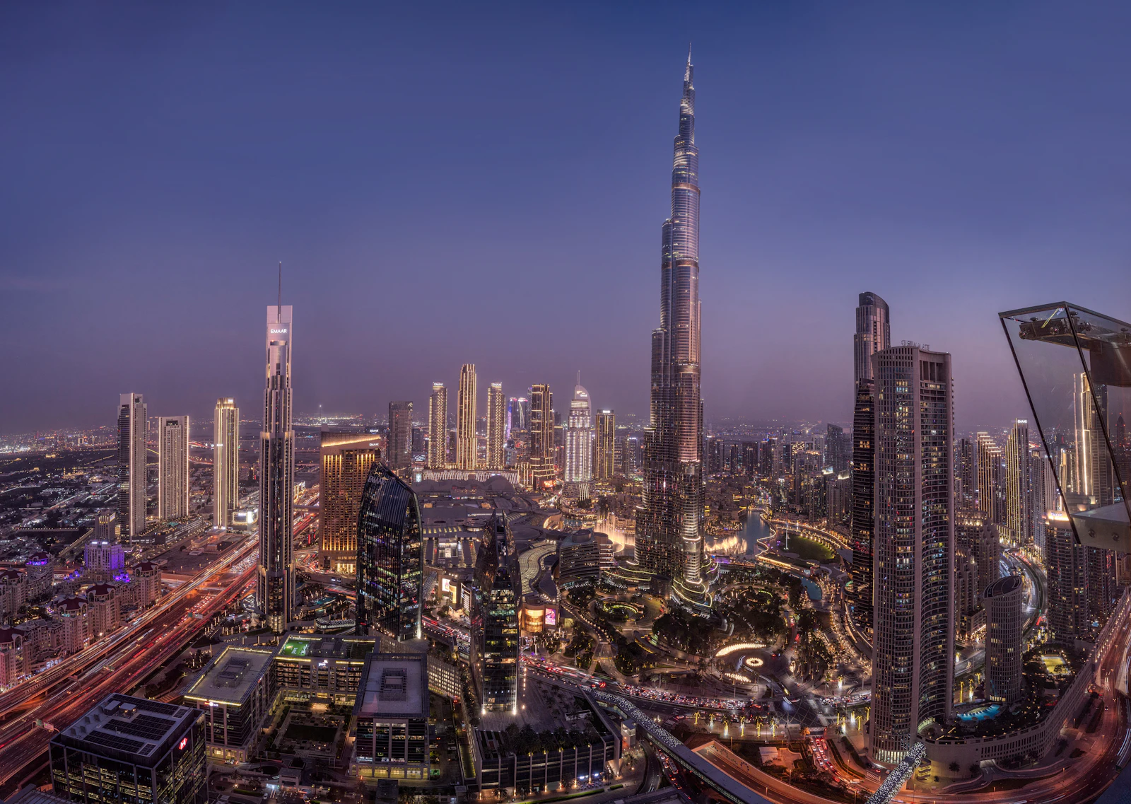 suzu abroad dubai downtown twilight Burj Khalifa and Downtown Dubai towers lit up at twilight