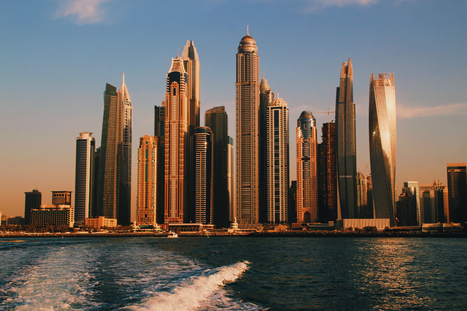 suzu abroad dubai marina skyline sea Dubai Marina skyscrapers seen from a boat on the sea at sunset
