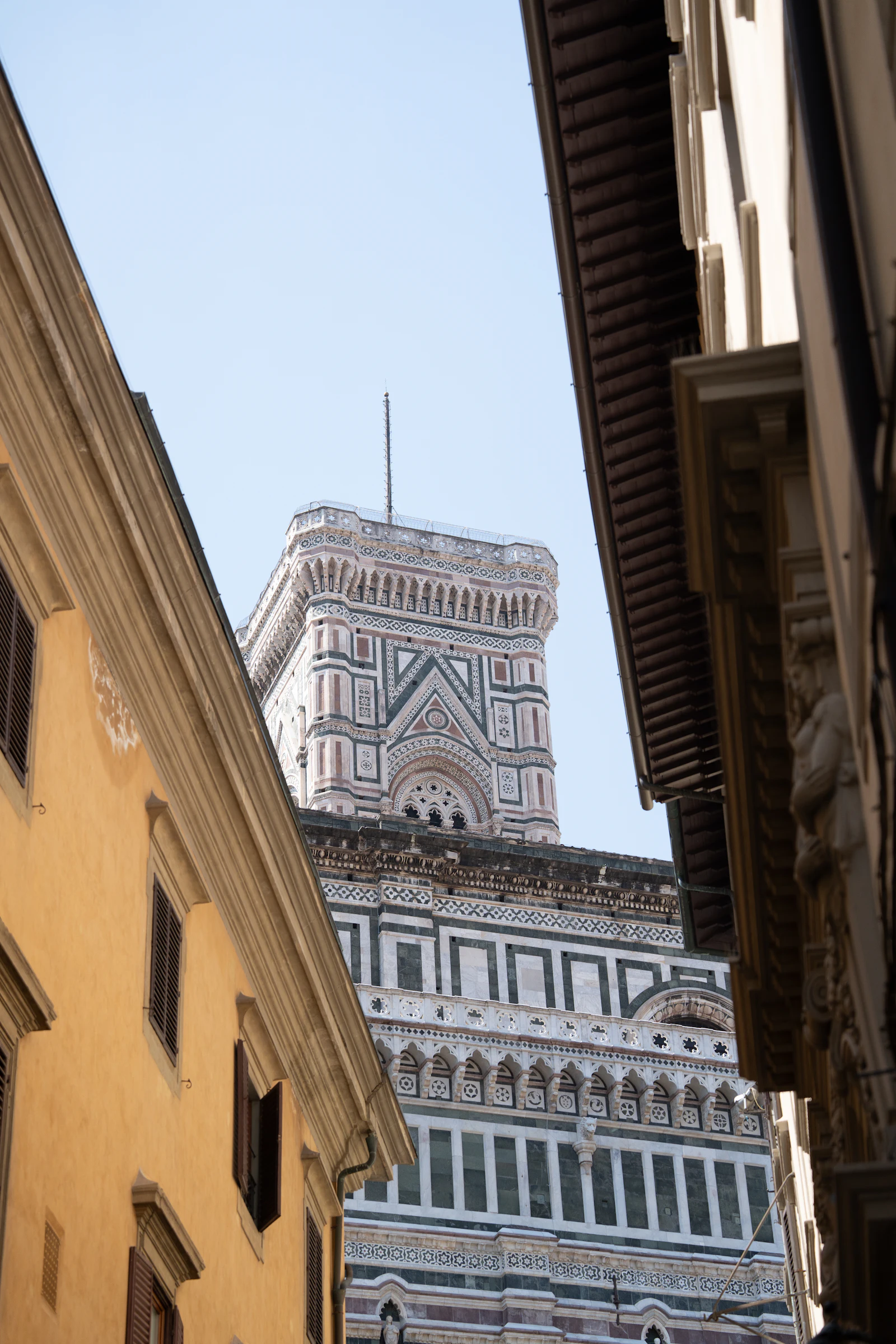 suzu abroad europe florence duomo campanile Giotto's bell tower and the marble walls of Florence Cathedral seen from a narrow street, Florence, Italy