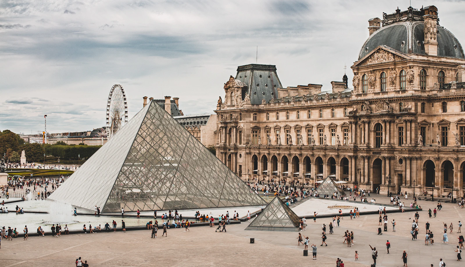 suzu abroad europe paris louvre Louvre Museum and its glass pyramid with visitors in the courtyard, Paris, France