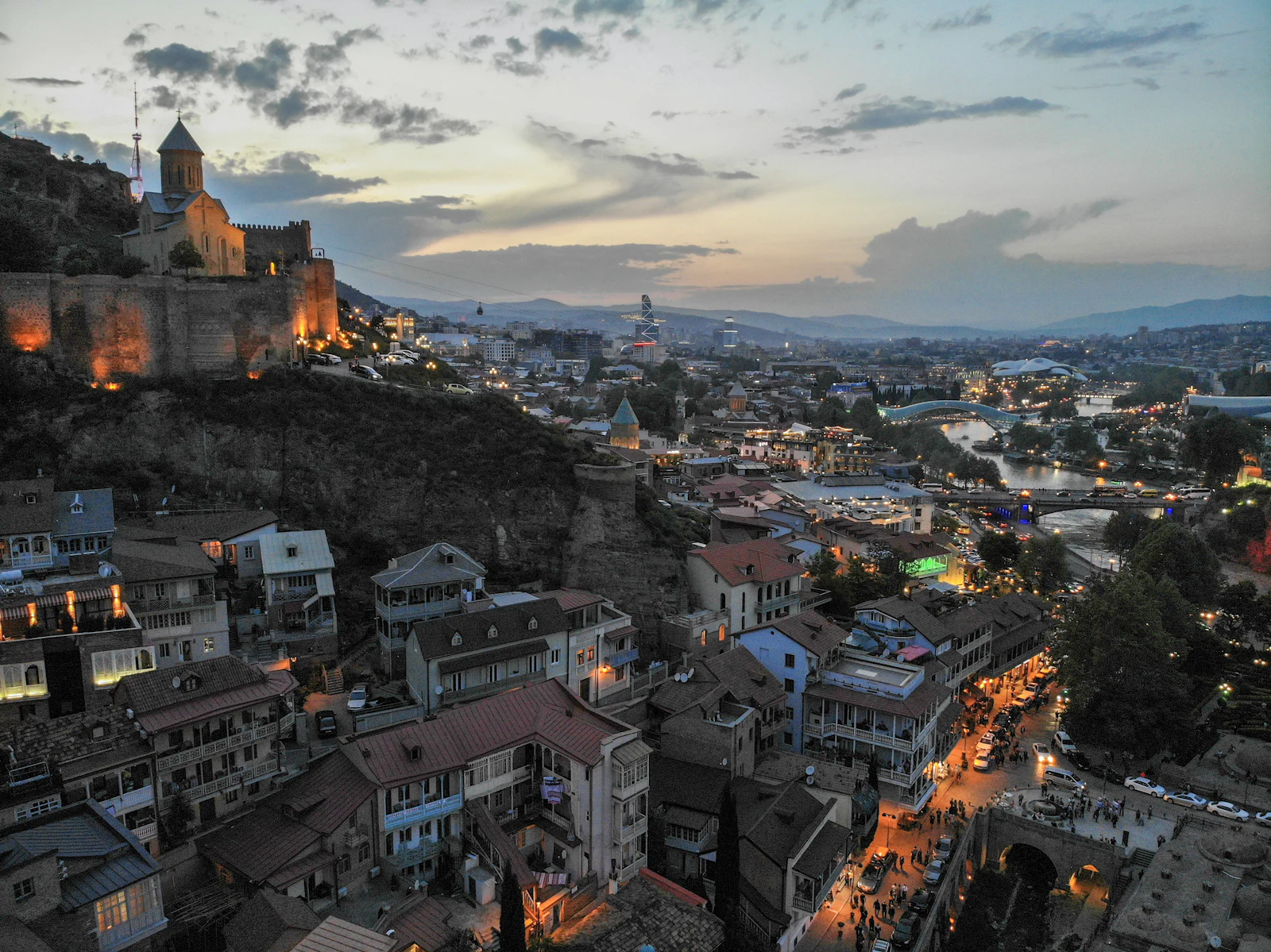 suzu abroad georgia tbilisi old town dusk Aerial view of Tbilisi old town at dusk with the lit Narikala fortress walls on the hill, Georgia