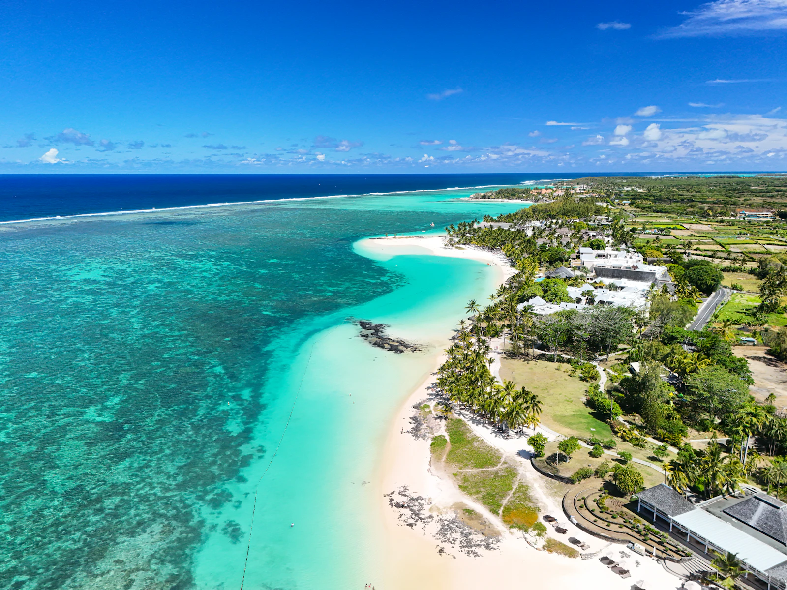 suzu abroad mauritius belle mare coast Aerial view of the turquoise lagoon and white beach at Belle Mare on the east coast of Mauritius