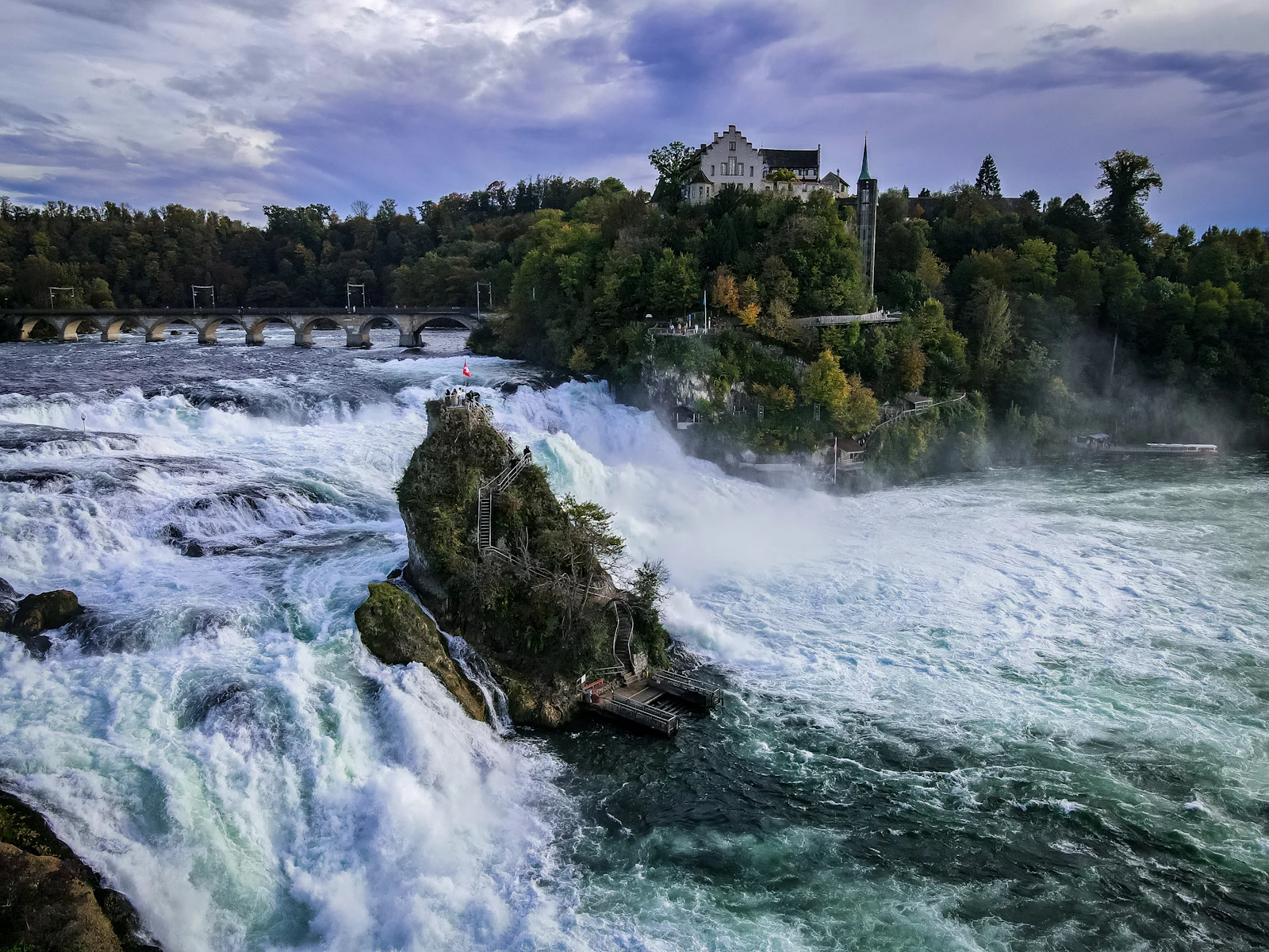 suzu abroad switzerland rhine falls Rhine Falls from above, with the rock in the middle of the falls and Laufen Castle on the wooded bank, Switzerland