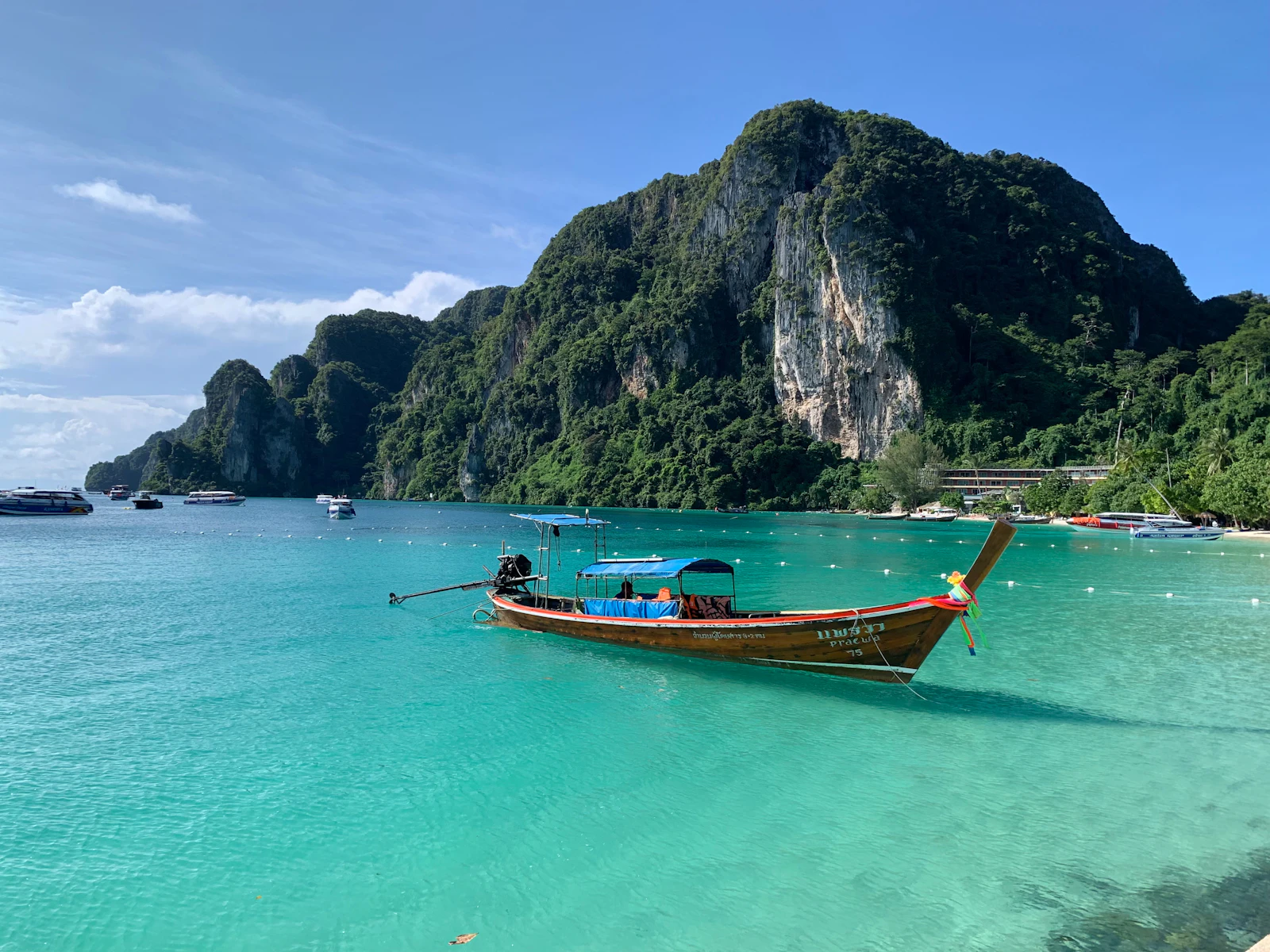suzu abroad thailand 1 Longtail boat on turquoise water below limestone cliffs, Phi Phi Islands, Thailand
