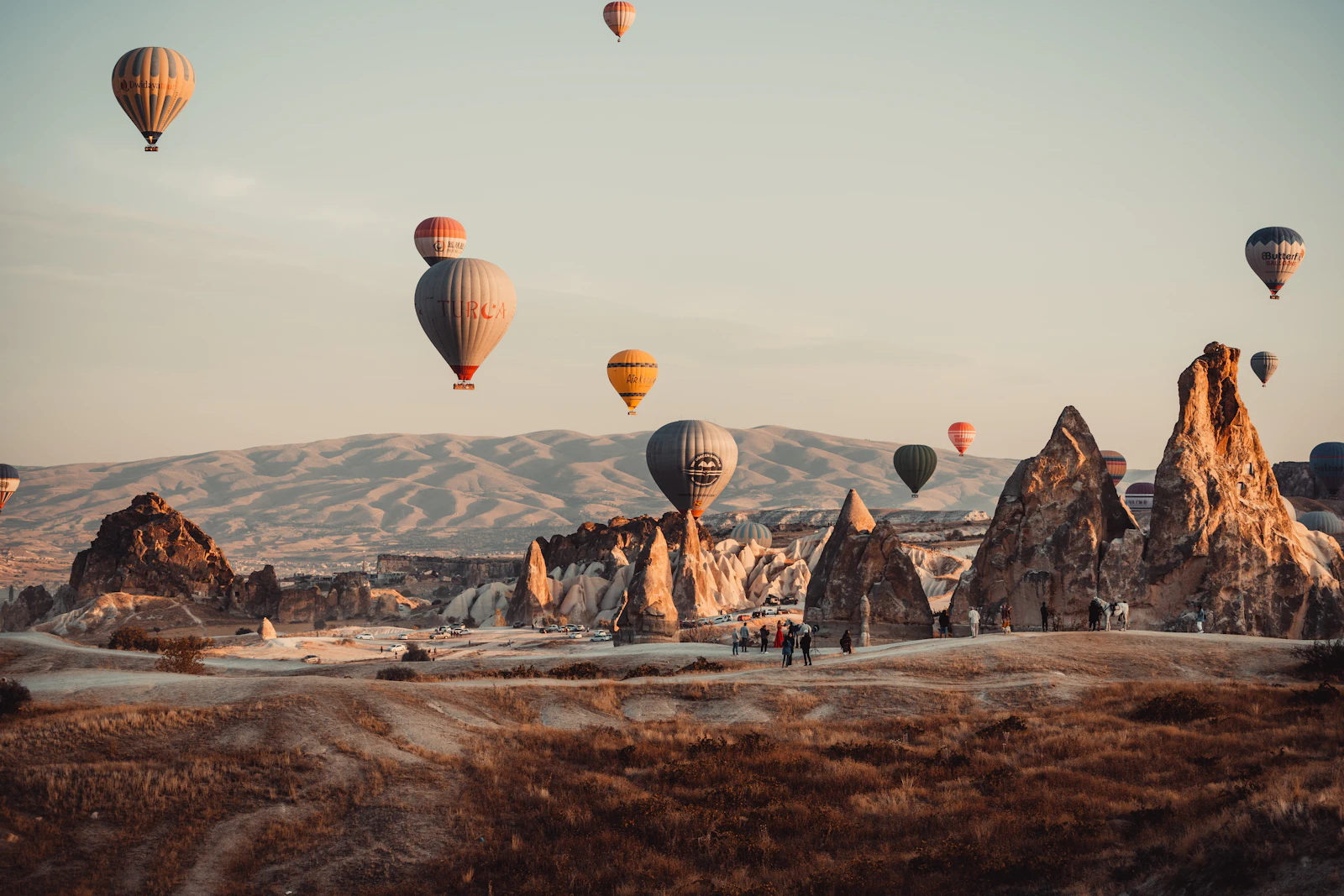 Hot-air balloons rising over the rock formations of Cappadocia, Turkey