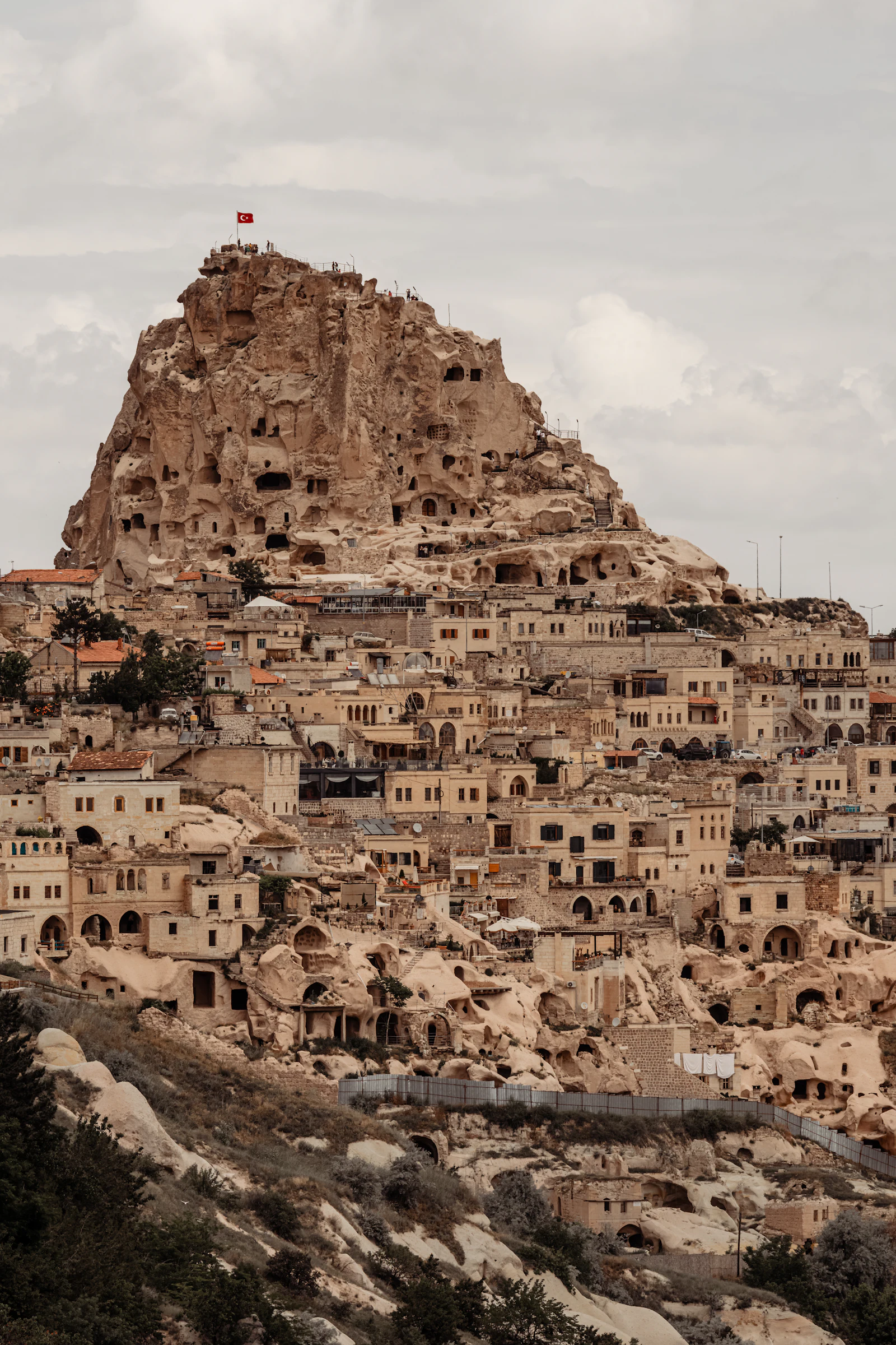 suzu abroad turkey cappadocia rock village A rock castle above the stone cave houses of a village in Cappadocia, Turkey