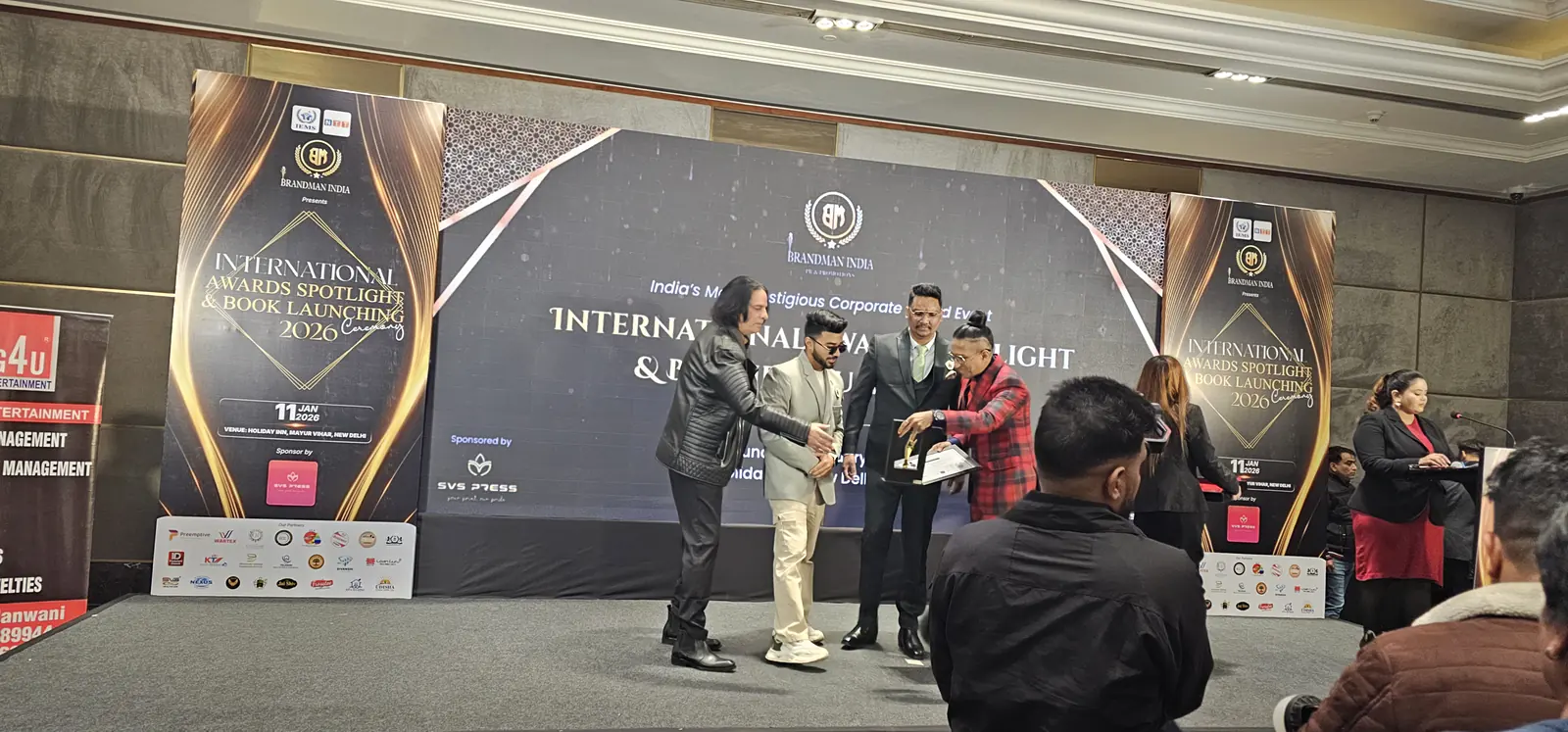 suzu travels receiving award on stage 2026 Suzu Travels team receiving an award on stage at International Awards Spotlight 2026